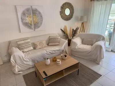 a living room with two couches and a coffee table at Elegant Apartment with Sea View and Swimming pool in Nice