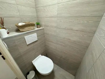 a small bathroom with a toilet and a sink at Elegant Apartment with Sea View and Swimming pool in Nice