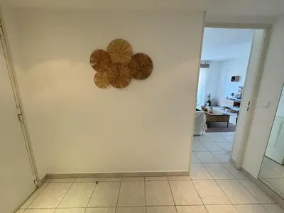 a room with two wooden plates on the wall at Elegant Apartment with Sea View and Swimming pool in Nice