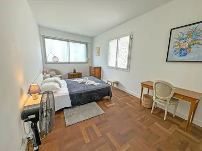 a bedroom with a bed and a desk and a table at Milord Promenade 4 in Nice