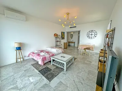 a bedroom with a bed and a table at Milord Promenade 4 in Nice