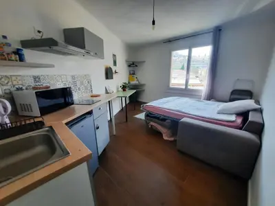 a small kitchen with a bed in a room at La Chambre 3, Climatisée AC, Cuisine privée, Calme in Nice