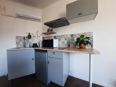 a kitchen with white cabinets and a counter top at La Chambre 3, Climatisée AC, Cuisine privée, Calme in Nice