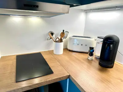 a wooden counter top with a coffee maker and utensils at Superbe duplex entre le Vieux Nice et la Prom in Nice