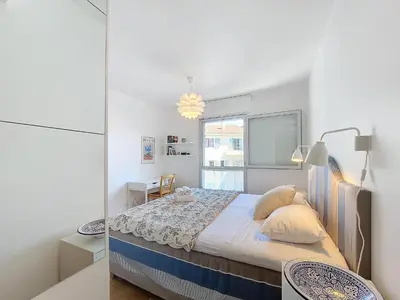 a small bedroom with a bed and a window at Nestor&Jeeves - VAGUE AZUR - Balcony - Central in Nice