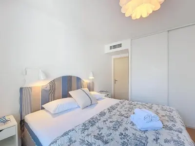 a bedroom with a bed with two towels on it at Nestor&Jeeves - VAGUE AZUR - Balcony - Central in Nice