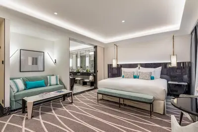 a bedroom with a bed and a couch and a table at Maison Albar - Le Victoria in Nice