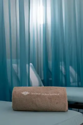 a brown box sitting on top of a bed with blue curtains at Maison Albar - Le Victoria in Nice