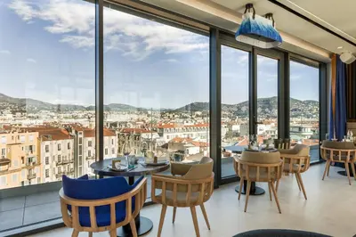 a restaurant with a view of a city at Maison Albar - Le Victoria in Nice