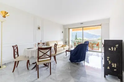 a living room with a table and chairs at Happyfew Le Floreal in Nice