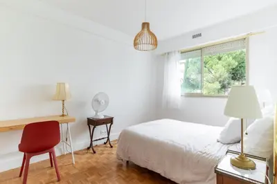 a bedroom with a bed and a desk and a window at Happyfew Le Floreal in Nice