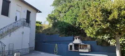 a blue fence next to a house with a bell at Appartement 4 p neuf dans haut de villa , clim, parking, jardin in Saint-Laurent-du-Var