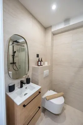 a bathroom with a sink and a toilet and a mirror at Studio idéalement situé résidence front de mer in Saint-Laurent-du-Var