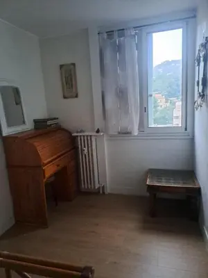 a living room with a piano and a window at La bella vista in Nice