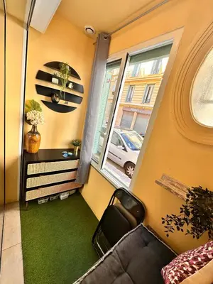 a living room with a couch and a window at Studio Coeur Delille FSHH in Nice