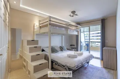 a bedroom with a bunk bed with a ladder at Suite HAITI FSHH in Saint-Laurent-du-Var
