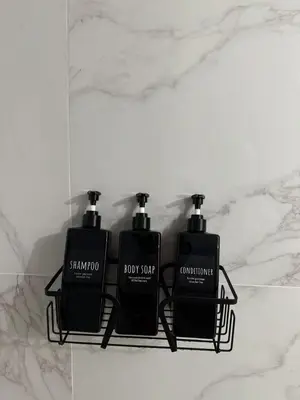 two black bottles of soap sitting on a counter at Jolie deux pièces au cœur de Nice in Nice
