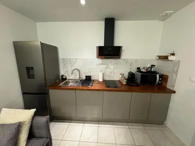 a kitchen with a sink and a counter with a microwave at Jolie deux pièces au cœur de Nice in Nice