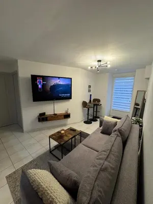 a living room with a couch and a flat screen tv at Jolie deux pièces au cœur de Nice in Nice