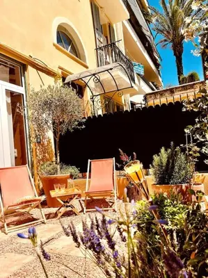 two chairs and plants in front of a building at Nice - Amazing flat to 10 min to sea - Garden in Nice