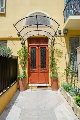 a red front door of a house with plants at Nice - Amazing flat to 10 min to sea - Garden in Nice
