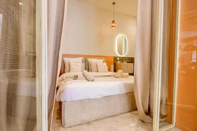 a bedroom with a large bed and a shower at Nice - Amazing flat to 10 min to sea - Garden in Nice