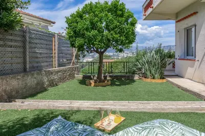 a yard with a tree and a fence at #54 Sea view Villa 4 BDR AC 5mins to Port BBQ in Nice