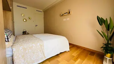 a bedroom with a white bed and a plant at Super logement - Mer à 5 min à pieds ! in Nice