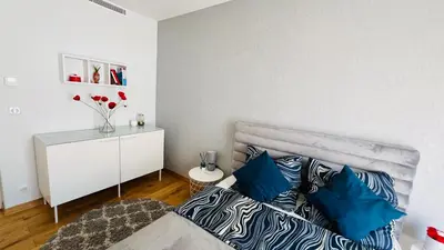 a bedroom with a bed with blue pillows at Super logement - Mer à 5 min à pieds ! in Nice