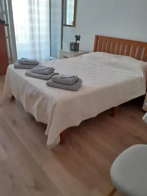 a bed with three towels sitting on top of it at Maria in Nice