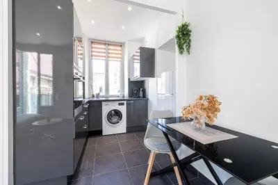 a kitchen with a table and a washing machine at Large & Quiet 1 Bdr at Nice Port in Nice