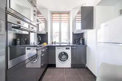 a kitchen with a washing machine and a washer at Large & Quiet 1 Bdr at Nice Port in Nice