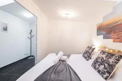 a bedroom with a bed and a painting on the wall at Large & Quiet 1 Bdr at Nice Port in Nice