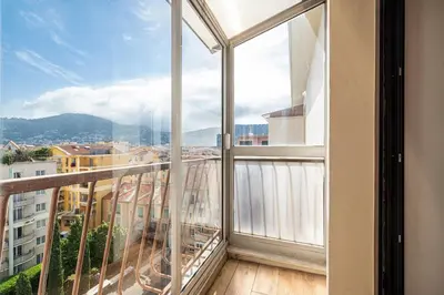 an apartment balcony with a view of a city at Open Sky Terrace Lage 1 Bdr & Parking in Nice