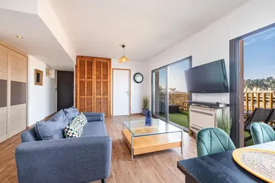 a living room with a couch and a tv at Open Sky Terrace Lage 1 Bdr & Parking in Nice