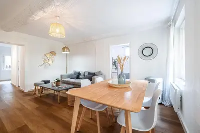 a dining room and living room with a wooden table at 2 Bdr Heart of the Old Town in Nice
