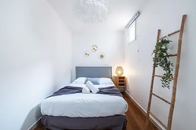 a small bedroom with a bed and a ladder at 2 Bdr Heart of the Old Town in Nice
