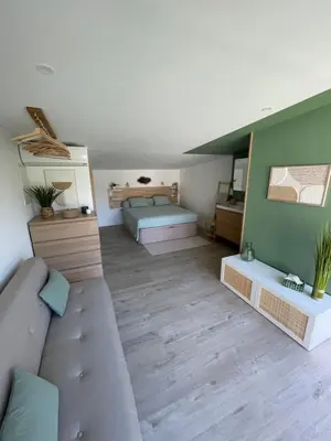 a living room with a couch and a bed at La chambre de Cleron in Saint-Laurent-du-Var