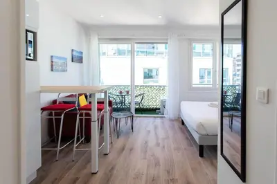a room with a bed and a table and chairs at #19 Lenval - Balcon Lenval Sea View with AC Promenade des Anglais in Nice