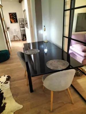 a dining room with two tables and two chairs at Movida in Nice