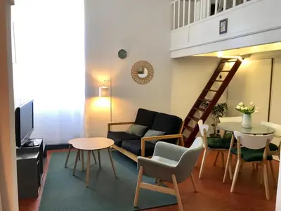 a living room with a couch and a table at Petit cocon in Villefranche-sur-Mer