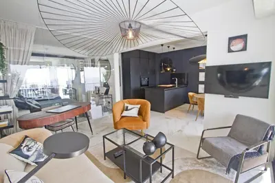 a living room with furniture and a large chandelier at Luxury Flat Beachfront Nice in Nice