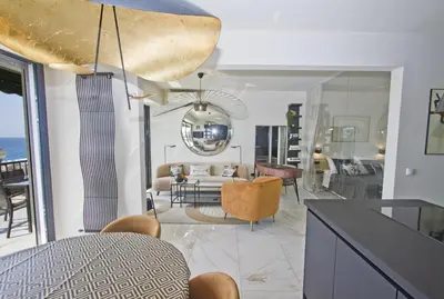 a kitchen and living room with a table and chairs at Luxury Flat Beachfront Nice in Nice