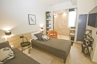 a bedroom with two beds and a living room at Luxury Flat Beachfront Nice in Nice