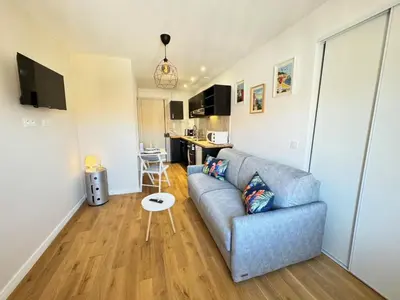 a living room with a couch and a table at APartHotel Riviera - COCON DE LA LIBERTE - Grimaldi - Promenade des Anglais in Nice