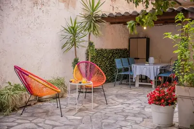 a patio with chairs and a table and a table and chairs at Charmant 4 pièces - Cour privative - Port de Nice in Nice