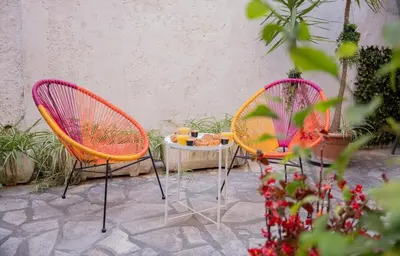 two chairs and a table on a patio at Charmant 4 pièces - Cour privative - Port de Nice in Nice