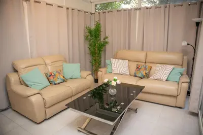 a living room with two couches and a coffee table at Charmant 4 pièces - Cour privative - Port de Nice in Nice