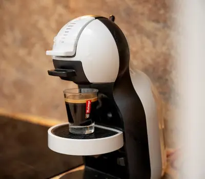 a black and white coffee maker with a cup at Charmant 4 pièces - Cour privative - Port de Nice in Nice