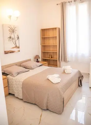a bedroom with two beds with towels on them at Charmant 4 pièces - Cour privative - Port de Nice in Nice